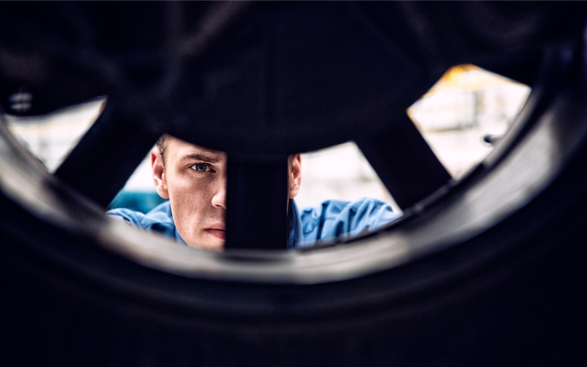 mechanic changes summer tyres on car
