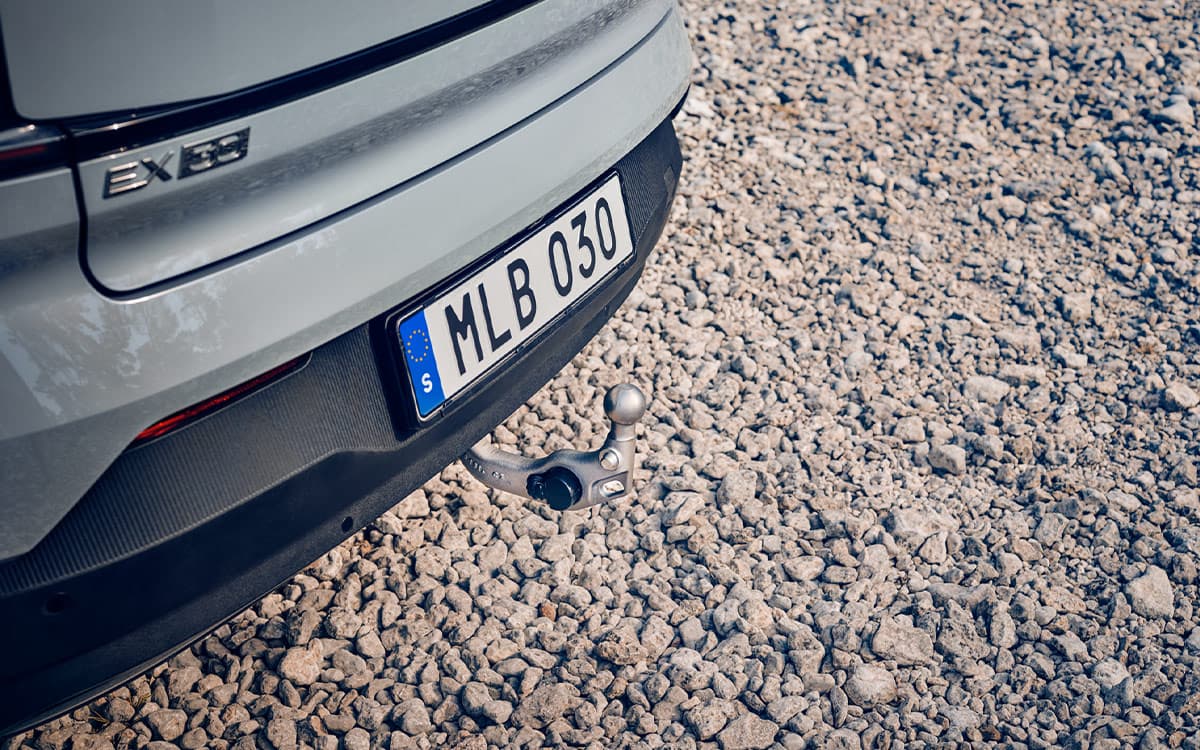 Volvo EX30 with folded-out towbar on gravel surface