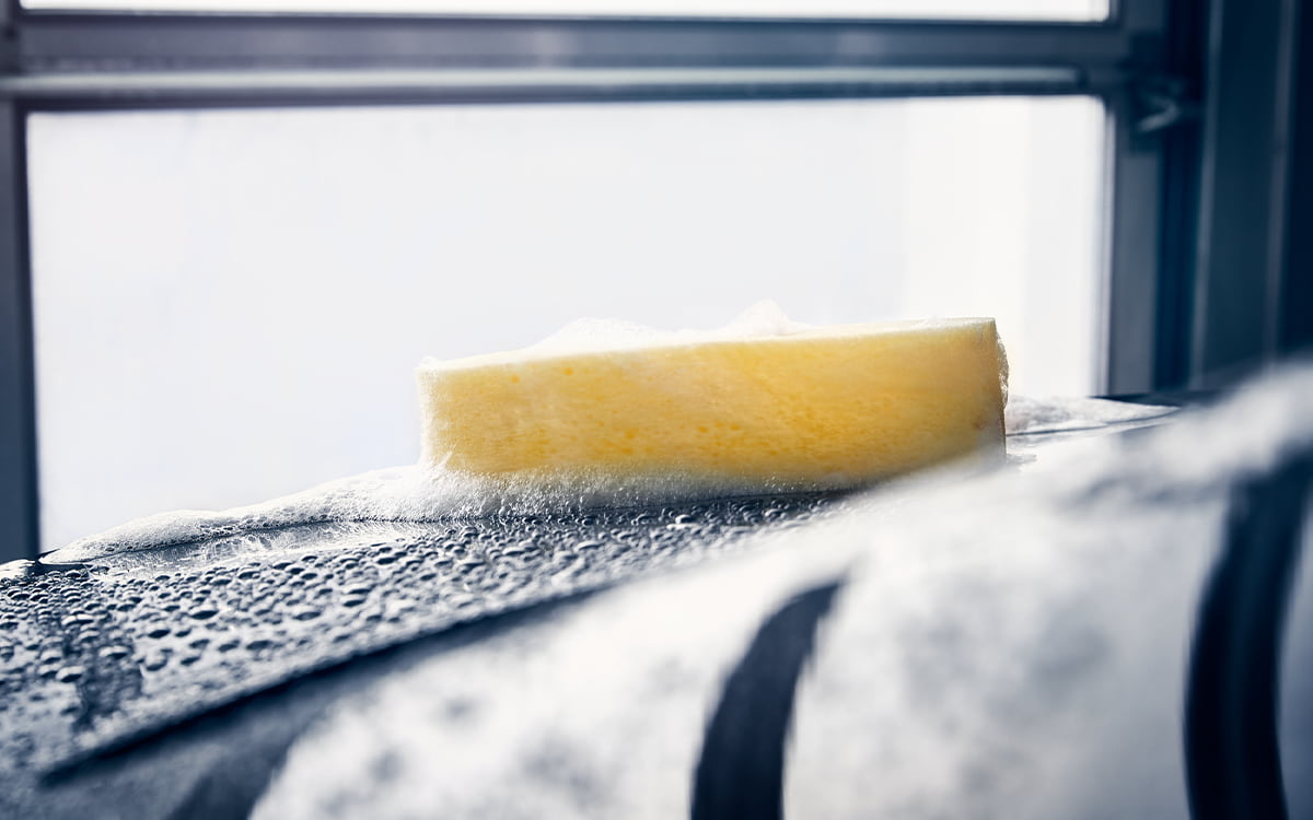 yellow sponge with foam in car wash in Zug